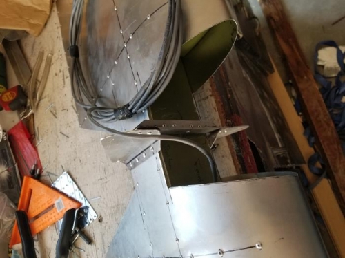 Riveted hinge bracket, L-bracket, and elevator horns in place