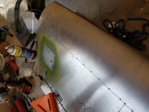 Riveted access panel over top of acces port for the electric trim actuator