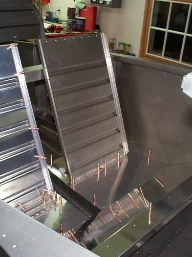 Seat backs and floor skins clecoed in place.