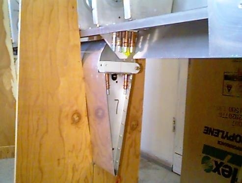 Inboard left aileron bracket clecoed in place.