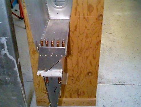 Outboard left aileron bracket clecoed in place.