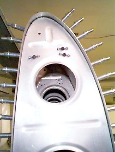 Plate nuts pop riveted into the wing ribs.