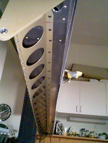 Flap brace riveted to the rear spar.