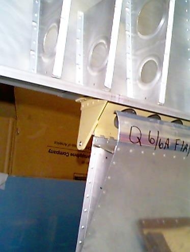 Left aileron bracket riveted in place.