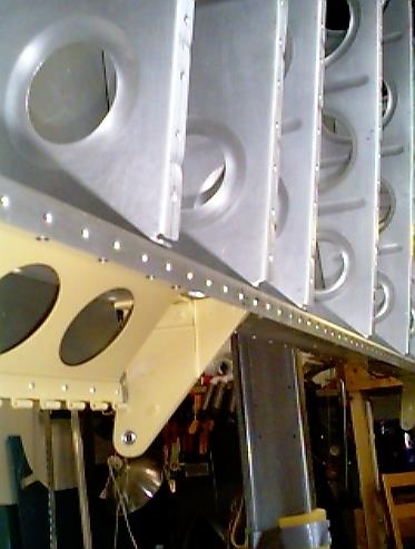 Right inboard aileron bracket riveted in place.