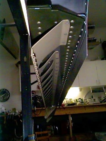 Right wing flap brace riveted in place.