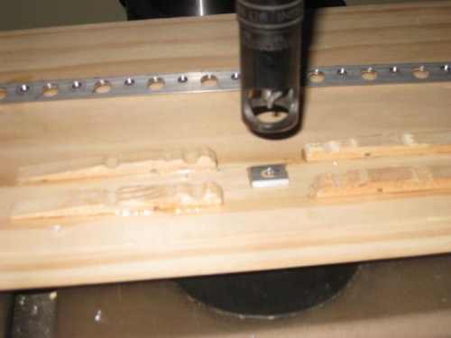 The small wedge is glued to the board and supports the trailing edge level