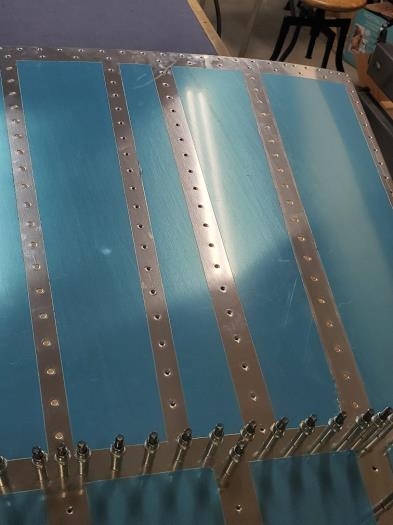 Outer longerons back riveted, inboard longerons bucked