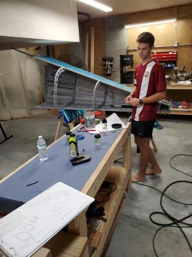 Preparing to rivet side skin to bottom skin