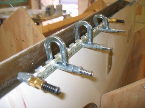 Scrap hinge half being used for a drill jig on wing bottom