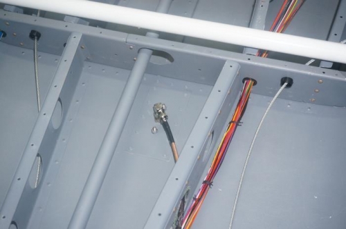 Wire bundle fastened to under floor structure and ADS-B coax