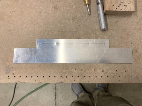 Layout and centerpunching of the 30 degree deflection lip mounting tab.