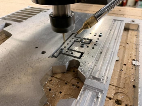 Cutting the linear actuator mounting brackets from aluminum stock on the CNC.