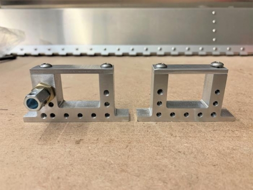 Mounting brackets after drilling, tapping, and mounting cable hardware.