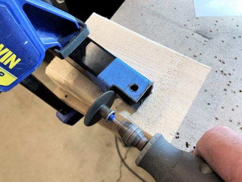 Cutting/shaping the flap drive arm end to the new design for the shorter stroke actuator.