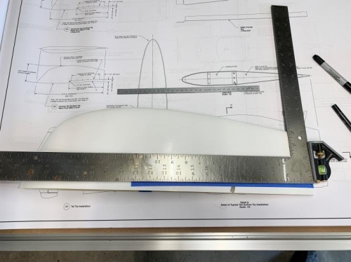 Marking intial trim cuts on the horizontal tail tip, ensuring long cuts are perpendicular to aft edge.