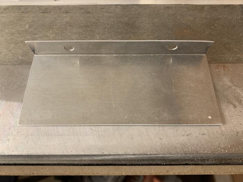 Fabricated a new longer mounting tab for the oil cooler air duct.