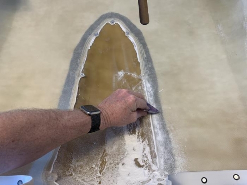Sanding the overflow adheasive on the inside to produce a smooth flowing seam on the interior joint.