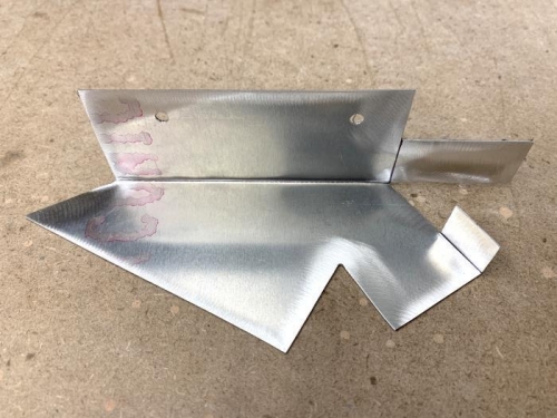 Sheet material with two of the three metal folds.