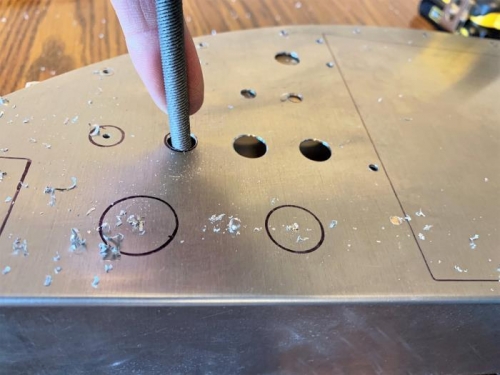 Cleaning up a slightly off-center drilled-out hole so it matches up with the panel overlay.