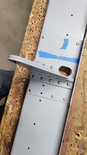 Inboard aileron hinge assembly attached to spar