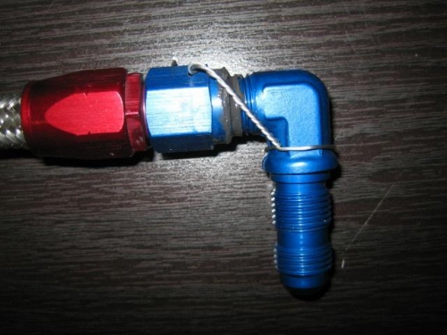 Flop tube fitting safety wired