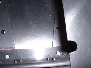 Notch in skin at rear spar