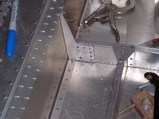 Riveted spacer on control stick bracket