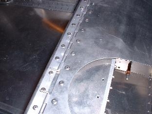 Front seat hinge riveted