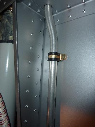 Oil separator outlet tube extending down in front of the firewall