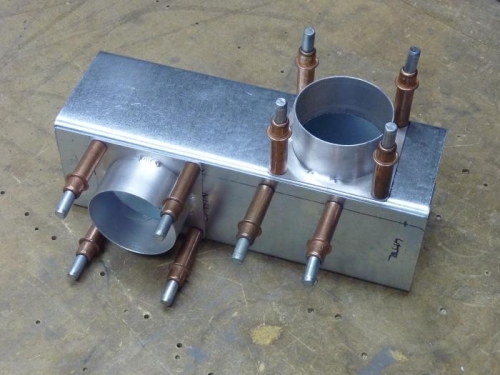 The muff with a duct flange to cabin heat (left) and carb heat (right)