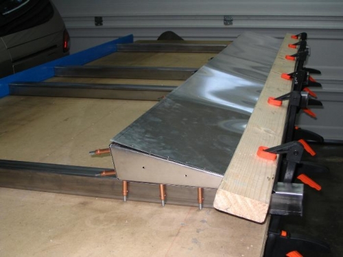 Skin clamped to steel supports to eliminate twist