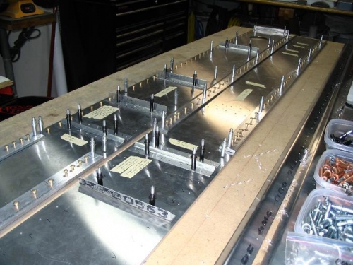 One row of 5-9 rivet holes on far side