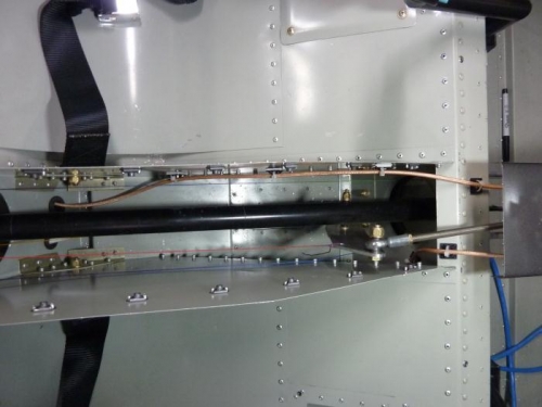 Through the tunnel for the comm coax - transponder coax ducks under the seat