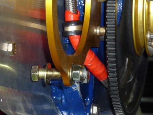Oil line clamps to back of alternator dog bone