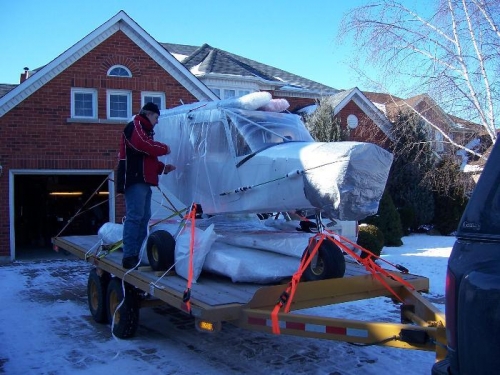 Carl securing the CH 701 ...wings underneath the plane