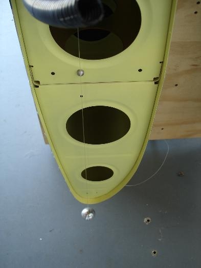 Plumb bob used to align aileron trailing edge with tooling holes