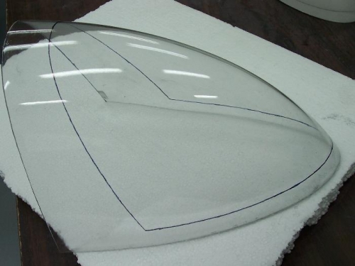 Plexiglass lens marked for cut