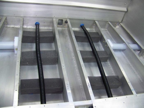Conduits and foam supports in baggage compartment