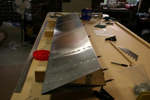 Top side of flap with riveting complete, bottom still to do