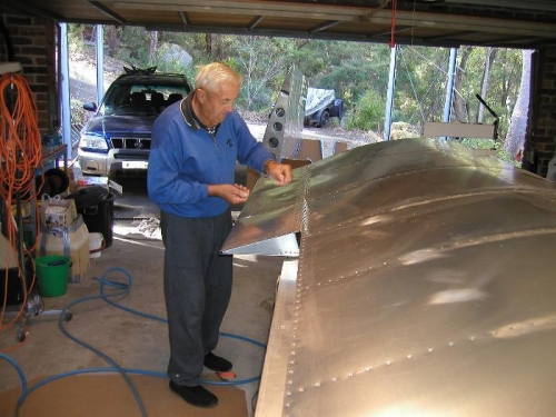 My dad inserting rivets in the aileron hinge while I followed and pulled them off.
