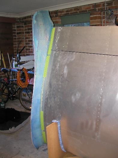 Fairing trimed and taped to the left wing to allow it to contine to harden