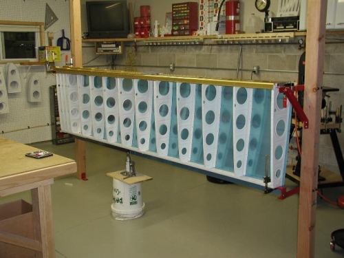 The top skins are clecoed to the wing .