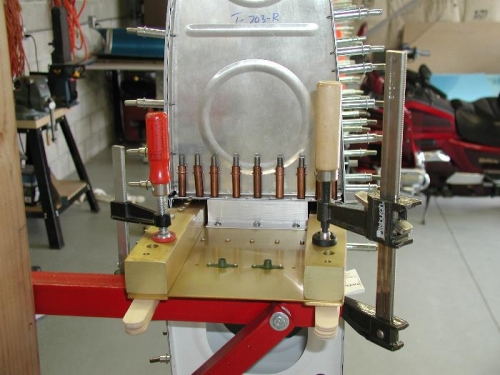 Angle brackets mounted to spar and fuel tank attached to it.