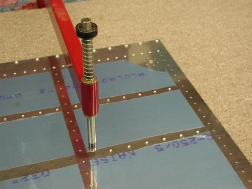 Dimpling the left fuel tank skins.