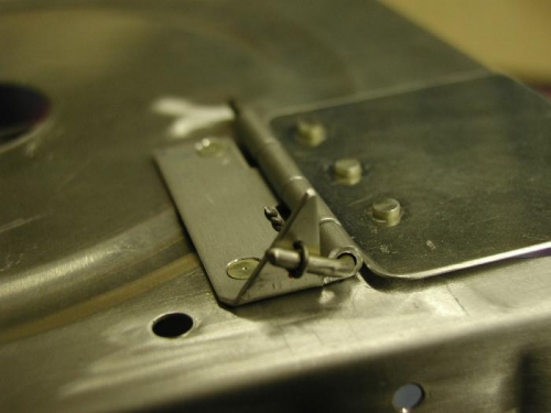 Safety wired the fuel trap door to the upper part of the hinge. drilled a .040 hole and safetyed.