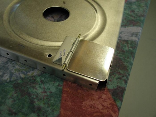 Trap door in fuel tank rib to prevent fuel from leaving the pickup tube in steep turns.