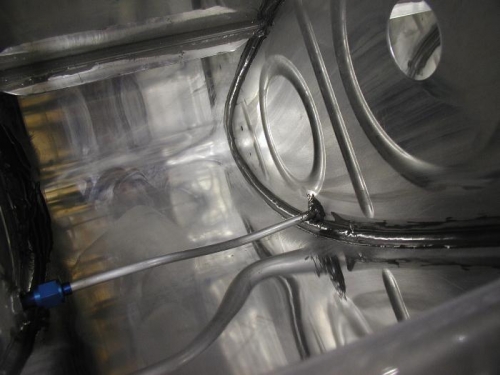 The vent line is attached with tank sealant at each rib for support.