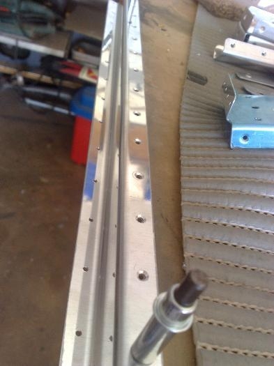 Countersinking holes on upper flange of trim tab spar
