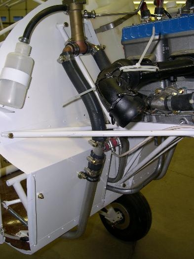 Relocated radiator hose